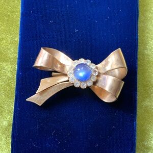 Coro Gold-Tone Bow Brooch with Blue Cabochon and Rhinestone Accents